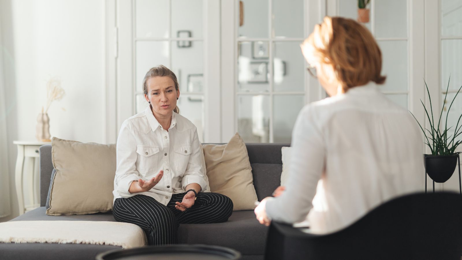 Adult woman discussing ADHD symptoms with a clinician during a consultation