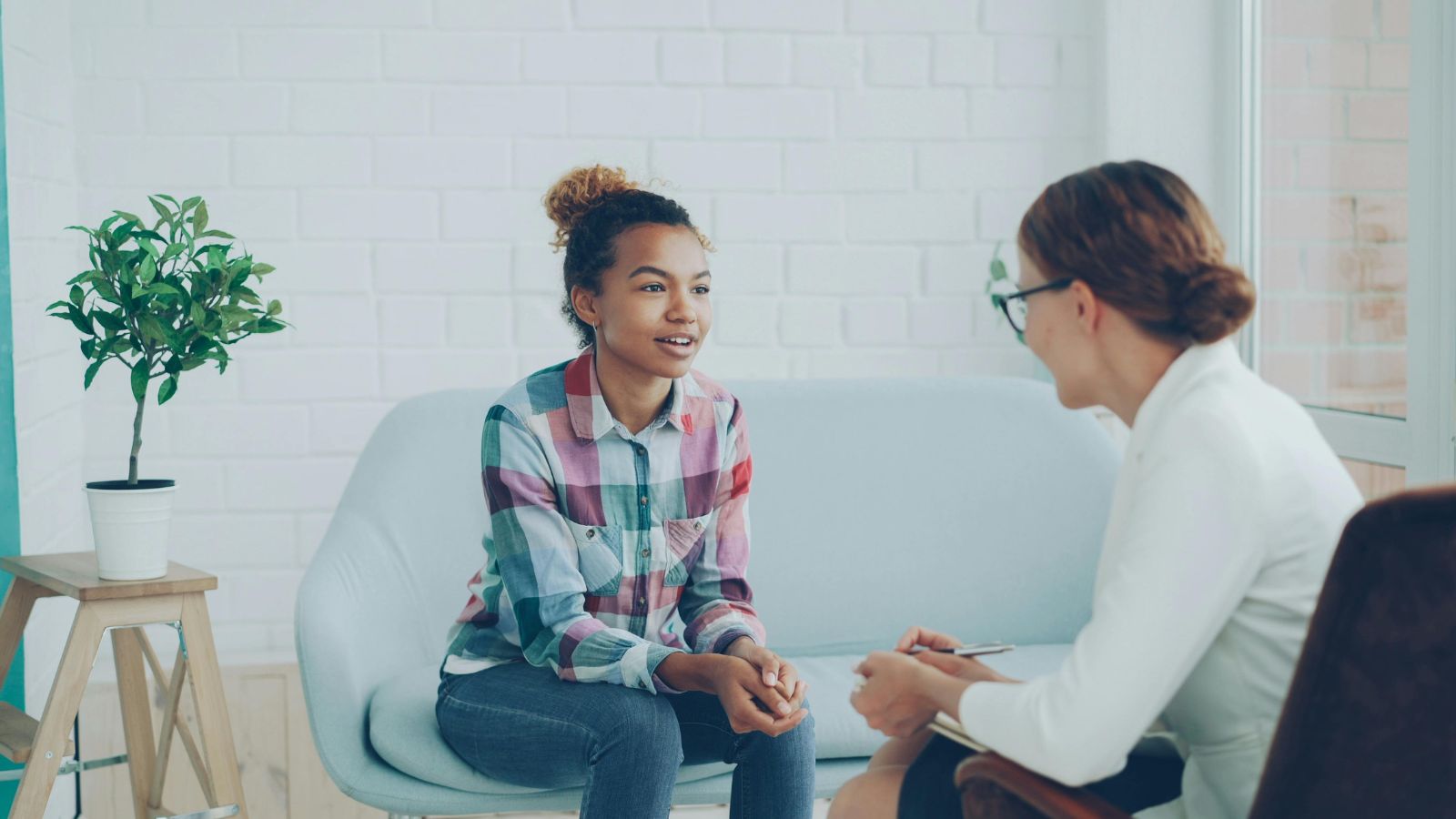 Teenager talking with a clinician during an ADHD assessment appointment